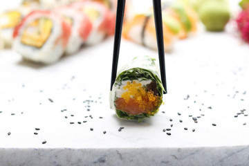 Sushi. Spring rolls, sushi rolls with salmon, rucola, philadelphia cheese.