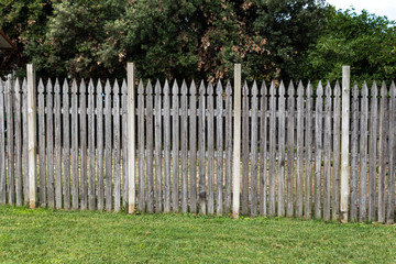 Wooden picket fence in the meadow