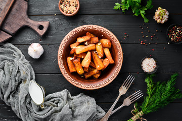 Potatoes fried with garlic. Ukrainian Traditional Cuisine. Top view. Free space for your text. Rustic style.