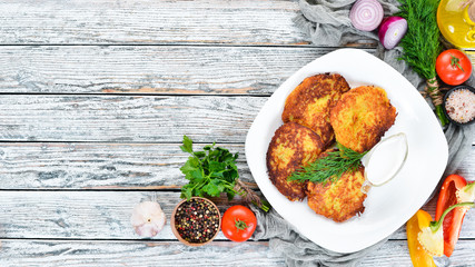 Potato pancakes with sour cream. Ukrainian Traditional Cuisine. Top view. Free space for your text. Rustic style.