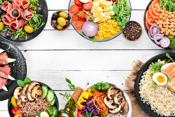 Buddha bowl on a white wooden background. Assortment of healthy food. Top view. Free space for your text.