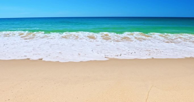 Calm slow motion background of sea waves wash on white sand beach