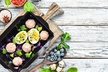 Healthy food and diet concept. Meat balls with egg and vegetables. restaurant dish delivery. Top view. Free space for your text.