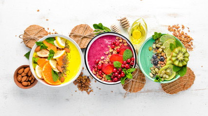 A healthy breakfast. Colorful fruit smoothies with yogurt, fresh fruit and berries. Top view. Free...