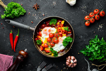 Shakshuka Eggs with tomatoes and vegetables in a frying pan. Breakfast. Top view. Free space for your text.