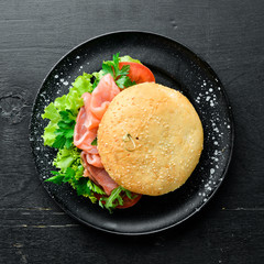 Burger with salmon, tomatoes and onions. Breakfast. Top view. Free space for your text.