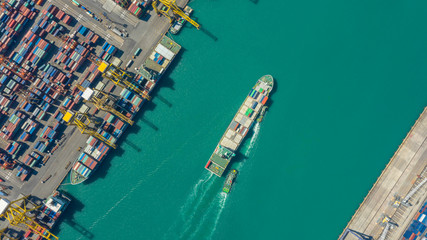 Container ship in export and import business logistics and transportation. Cargo and container box shipping to harbor by crane. Water transport International. Aerial view and top view.