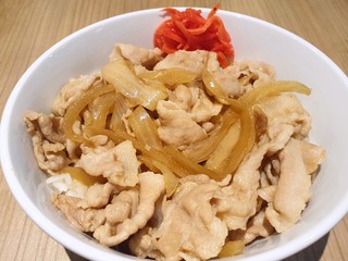 Japanese food style, Top view of roasted pork with teriyaki sauce in white bowl on wooden table in restaurant, Ready to eat