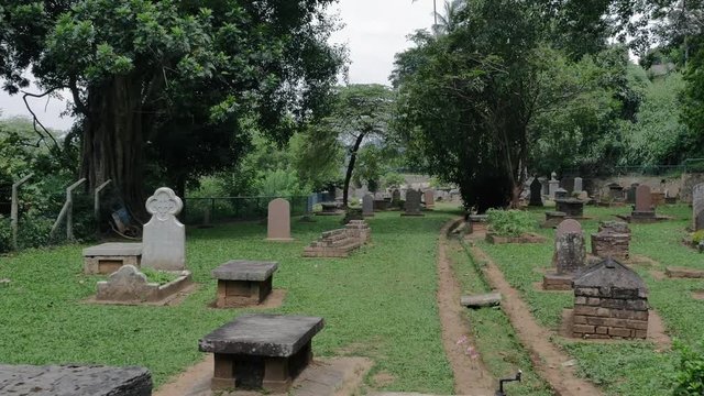 Visiting old British cemetery in Kandy town, Sri Lanka on Sri Dalada Maligawa temple site. Historical landmark of central Ceylon