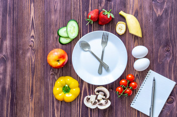  Food clock. The concept of healthy eating on a wooden background close-up