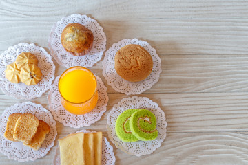 Orange Juice and Dessert on Wooden Table