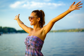 Fototapeta na wymiar happy woman posing by the river