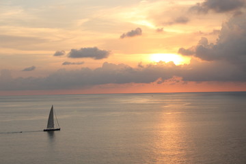 Sailboat in the ocean with sunset