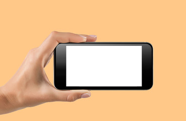 female teen hand holding smart phone , taking photo isolated on yellow background