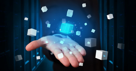 Person holding hologram projection displaying white cubes in server room
