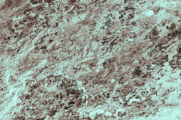 Vintage cyan background. Rough painted wall of hazel color. Imperfect plane of brown colored. Uneven old decorative toned backdrop of blue tint. Texture of azure hue. Ornamental stony surface.