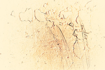 Vintage yellow background. Rough painted wall of aspen gold color. Imperfect plane of golden colored. Uneven old decorative toned backdrop of yellow tint. Texture of gold hue. Ornamental stony surface