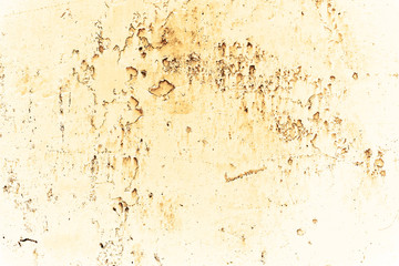 Vintage yellow background. Rough painted wall of aspen gold color. Imperfect plane of golden colored. Uneven old decorative toned backdrop of yellow tint. Texture of gold hue. Ornamental stony surface