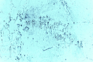 Vintage blue background. Rough painted wall of sapphire color. Imperfect plane of blue colored. Uneven old decorative toned backdrop of cyan tint. Texture of sapphirine hue. Ornamental stony surface.