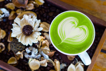 matcha green tea latte art top view on wood table 