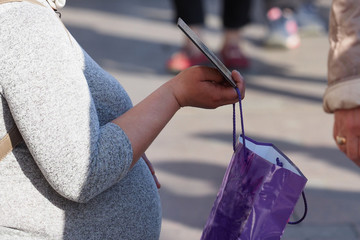 Beggar pregnant woman on the street asking for money. Beggars, social problem. Begging, praying