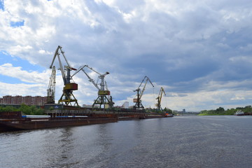 Port cranes on the river Tura. Tyumen river port. Russia Siberia.