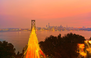 View of Bay Bridge across San Francisco Bay with lots of cars passing through in San Francisco at...