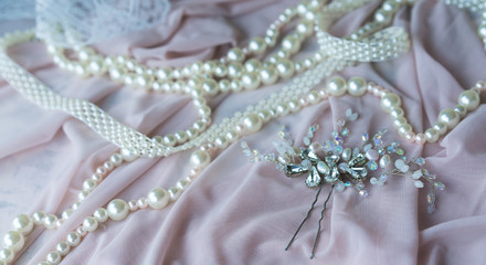 Wedding background with pearls and hair accessories on pink background