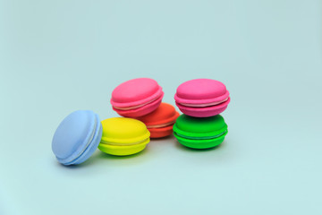 Multicolored macaroon cakes on a blue background. Imitation Cakes