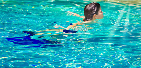 Boy in swimming pool. Cute teenage boy.