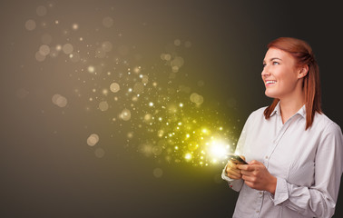 Person using phone with gold sparkling concept
