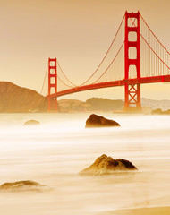 View of Golden Gate Bridge from Marshall's Beach in San Francisco at sunset.