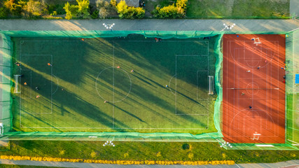 Aerial view of a sports field with footballers playing