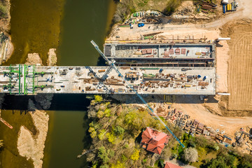Obraz premium Big construction of a bridge with high crane, aerial view