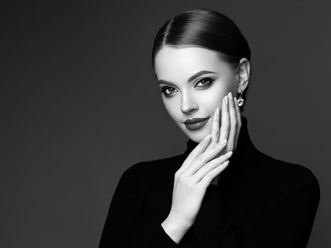 Beautiful Young Woman with Clean Fresh Skin. Perfect Makeup. Beauty Fashion. Plump Lips. Cosmetic Eyeshadow. Smooth Hair. Girl in Black Turtleneck. Black and white photo