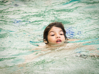 Boy in swimming pool. Cute teenage boy.