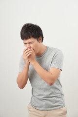 Mature man coughing on white background