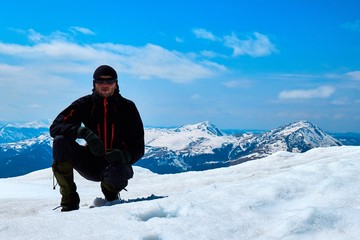 Fototapeta na wymiar lonely tourist on snowy mountain