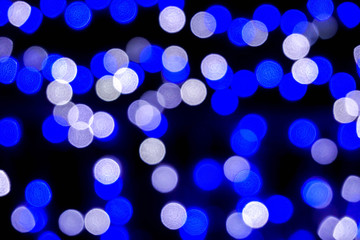 Closeup blue abstract blurred and bokeh of LED party light bubs reflection lighting at night time.