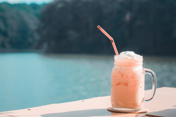 1 glass of Thai tea, placed on the table in the waterfront coffee shop.