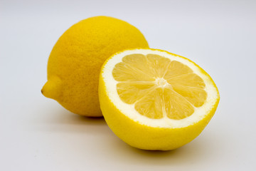 One lemon and half a lemon isolated image on a white background