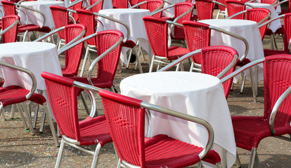 small tables and red chair in the alfresco cafe