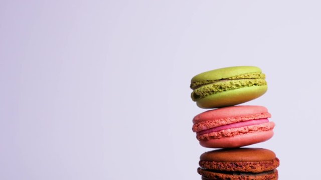 A colorful macaroons are rotating on white background