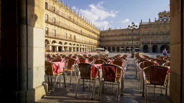 Walking the cafe with pink tables and wicker chairs at Plaza Mayor in Salamanca, Spain. Salamanca is a city in western part of the country in the community of Castile and Leon. 4K