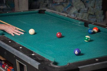 Billiards balls and cue on billiards table. Billiard sport concept