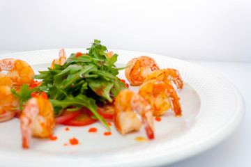fried king prawns and lettuce on white background