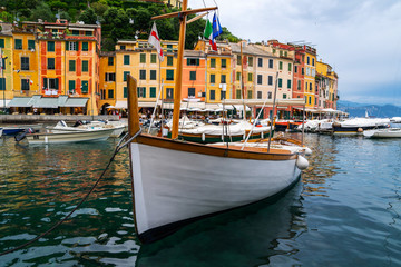 The beautiful Portofino panorama with colorfull houses, luxury boats and yacht in little bay harbor. Liguria, Italy. Postcard of Portofino. Travel and vacation concept.