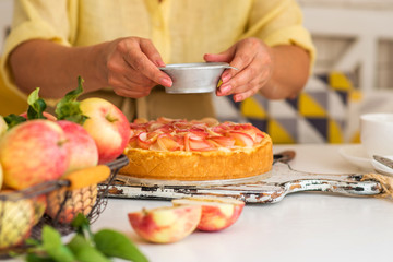 Woman make homemade apple pie. Confectioner make dessert. Apples on the table. Summer fruit dessert. Process of cooking apple pie, top view. Cooking and home concept.
