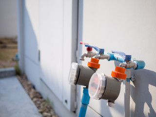 Faucets with gardening timer on the wall.