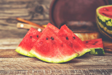 Watermelon background. Red watermelon slice on rustic table.